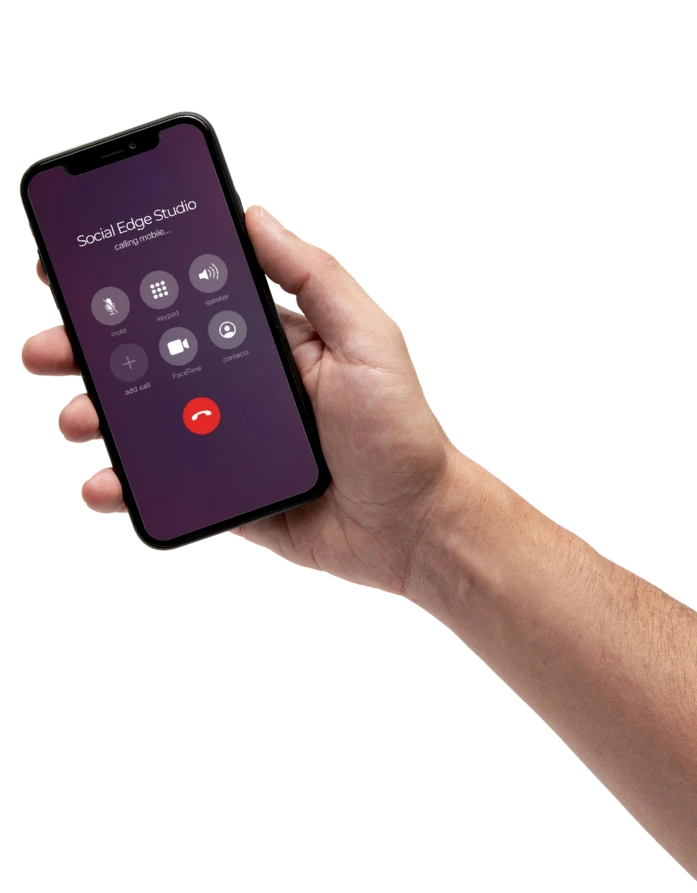 Hand holding a phone with caller ID Social Edge Studio.